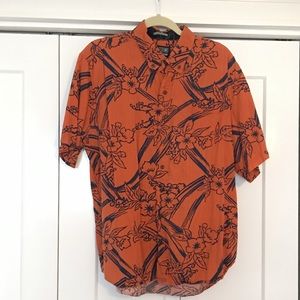 orange and blue aloha print shirt